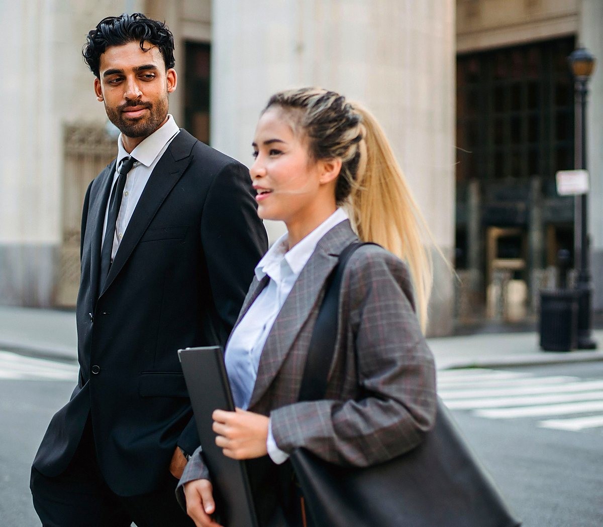 Dois profissionais caminhando juntos pela cidade